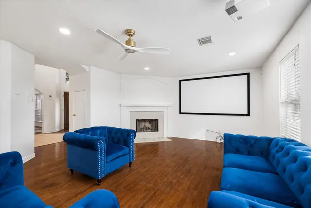 a living room with furniture wooden floor and a fireplace