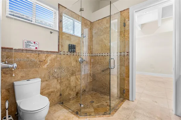 a bathroom with a shower and toilet