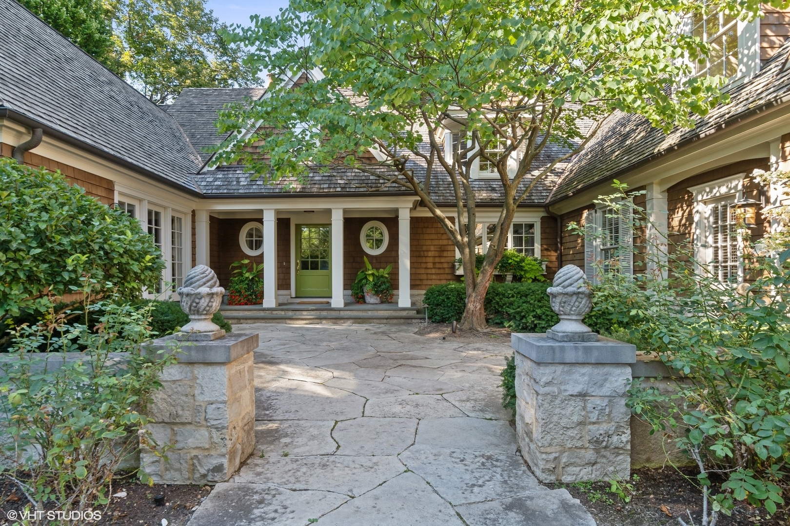 796 East Deerpath Road Lake Forest, IL 60045 - Photo 3 of 60 a view of a house with brick walls plants and large tree