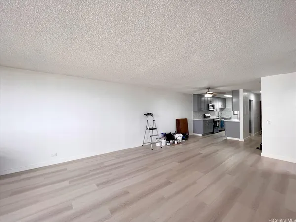 a view of a livingroom with wooden floor and furniture