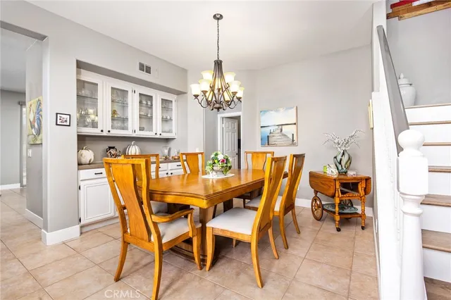 a dining room with furniture and chandelier