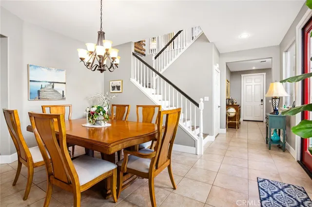 a dining room filled with lots of furniture and a chandelier