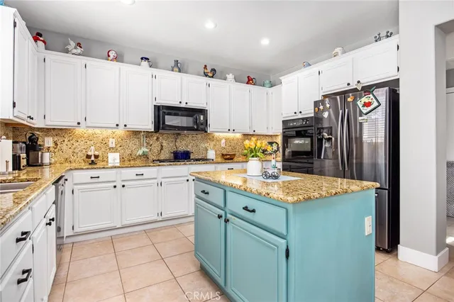 a kitchen with stainless steel appliances granite countertop a refrigerator sink and cabinets