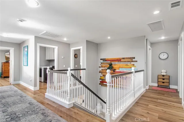 a view of a hallway with bedroom and stairs