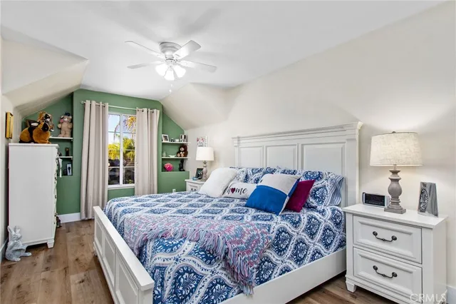 a bedroom with a large bed and a chandelier