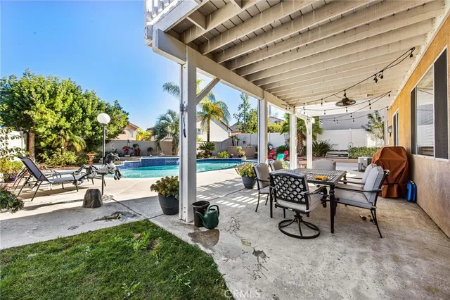 a view of a patio with table and chairs potted plants with wooden floor and fence