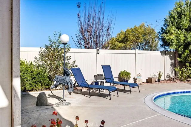 a swimming pool with outdoor seating