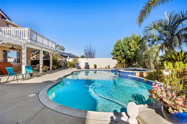 a swimming pool with outdoor seating and yard