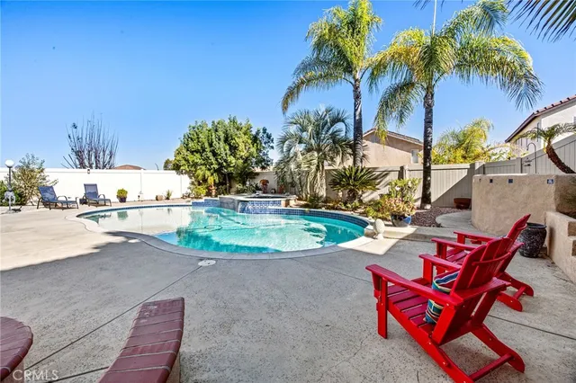 a view of a house with backyard and sitting area