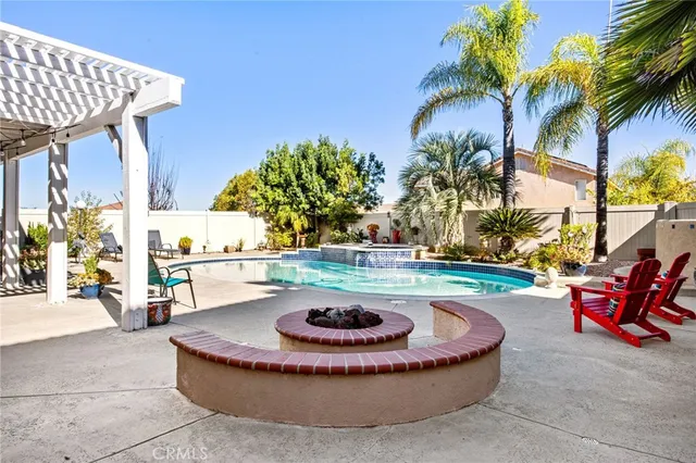 a backyard of a house with plants and palm tree