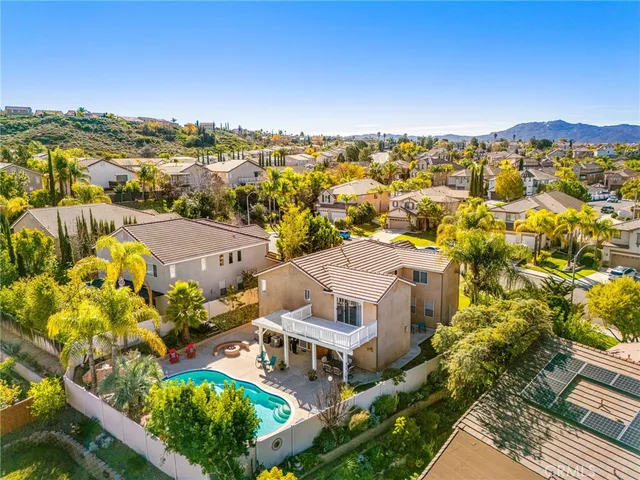 an aerial view of a house with a yard and garden