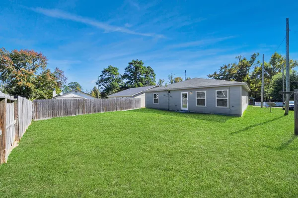 a view of house with backyard