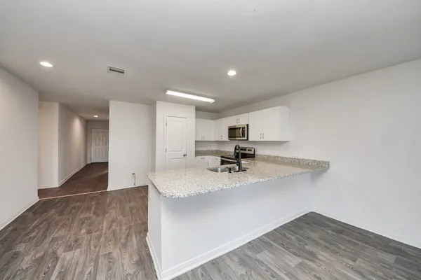 a kitchen with kitchen island sink refrigerator and stove