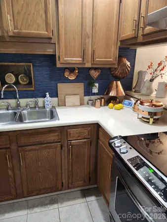 a kitchen with a sink stove and cabinets