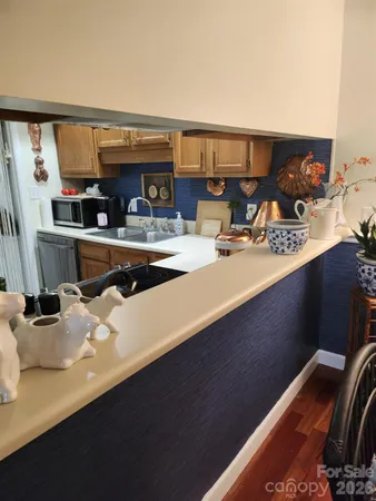 a kitchen with a sink appliances and cabinets