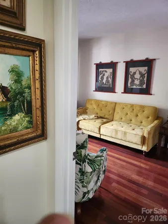 a bed sitting in a bedroom next to a window