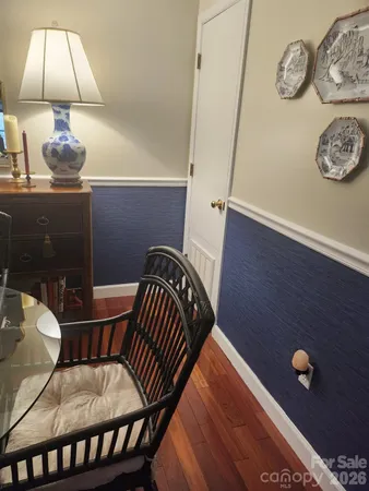 a view of a chairs and table in a wooden floor
