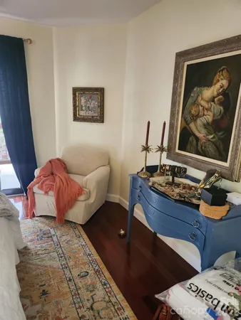 a living room with furniture and painting on the wall