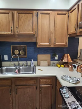 a kitchen with a sink a stove and cabinets
