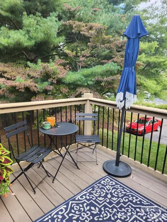 a view of a chairs and table in the roof deck