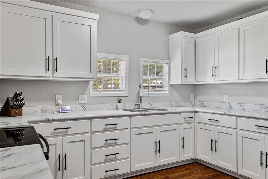 25 West Parnell Street Denison, TX 75020 - Photo 8 of 16 a kitchen with white cabinets and sink