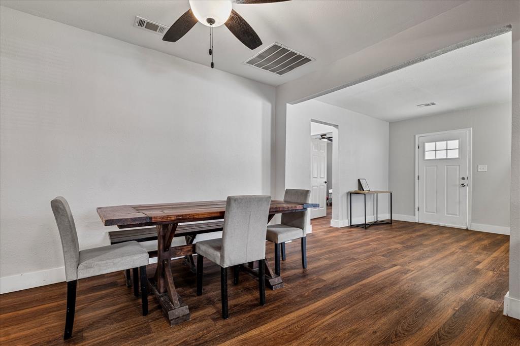 25 West Parnell Street Denison, TX 75020 - Photo 9 of 16 a view of a dining room with furniture and wooden floor