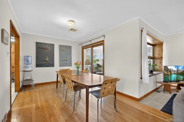 a dining room with furniture and window