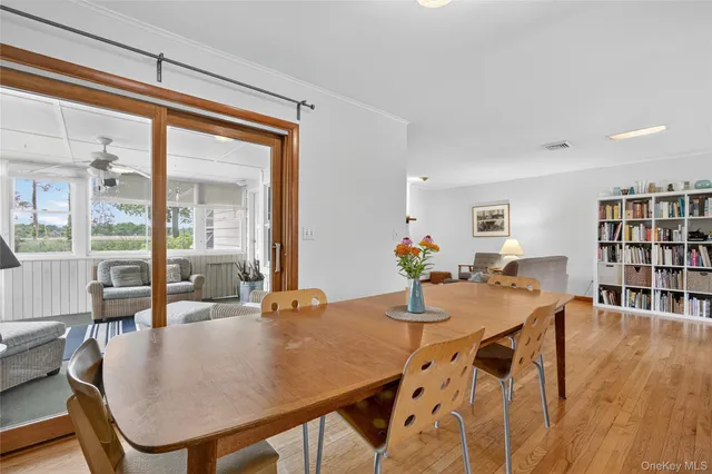 a dining room with furniture and wooden floor