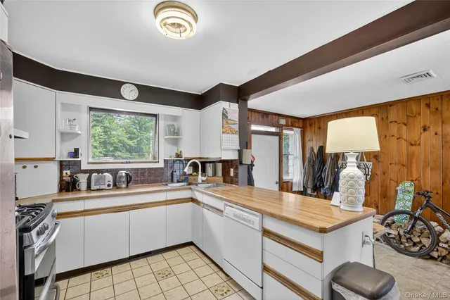 a large white kitchen with a large window