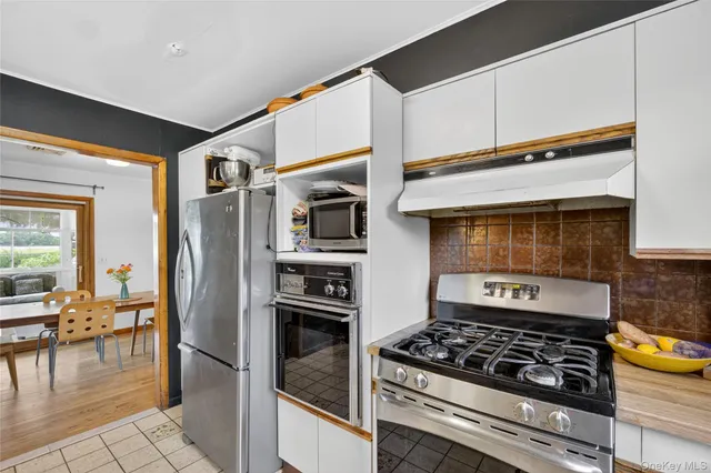 a kitchen with stainless steel appliances granite countertop a stove and a refrigerator