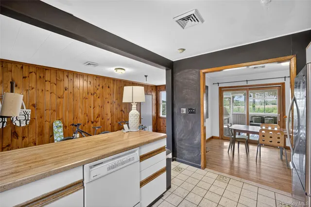 a bedroom with a large bed and wooden floor