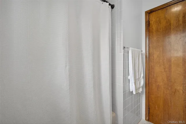 a view of an empty room with a window and a large window