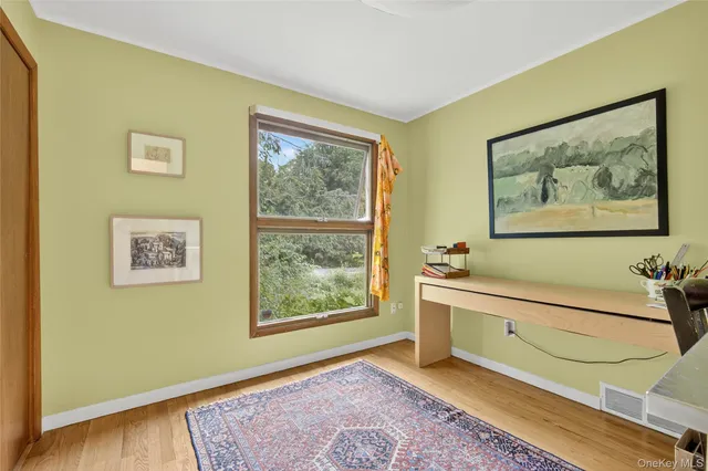 a view of an entryway with wooden floor and front door