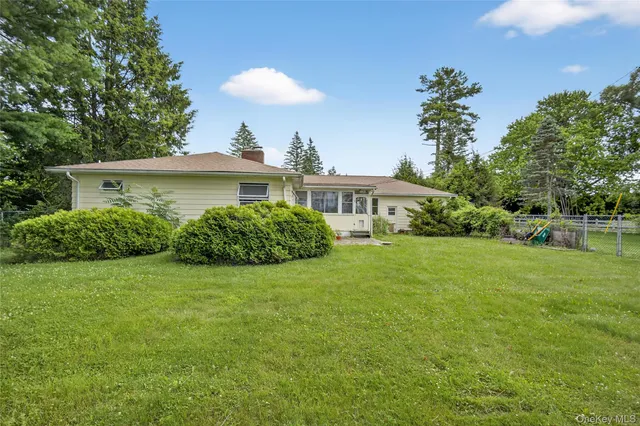 a view of a swimming pool with a yard