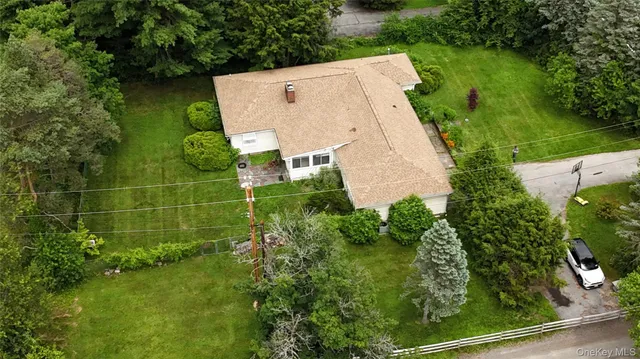 an aerial view of a house with a yard