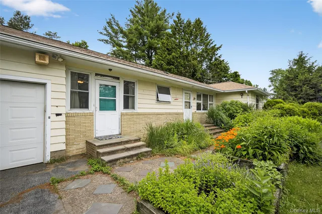 a front view of a house with garden
