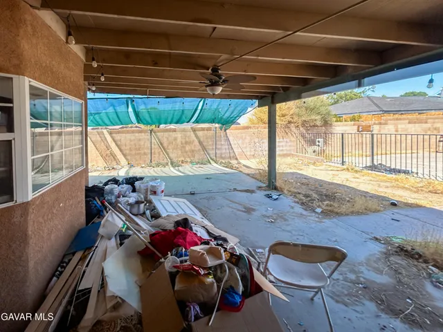 a view of a patio with table and chairs a barbeque with wooden floor and fence
