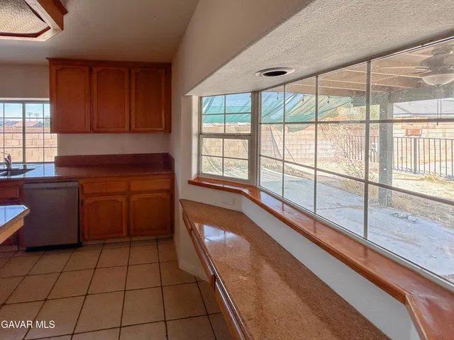 a view of a kitchen with a sink and cabinets