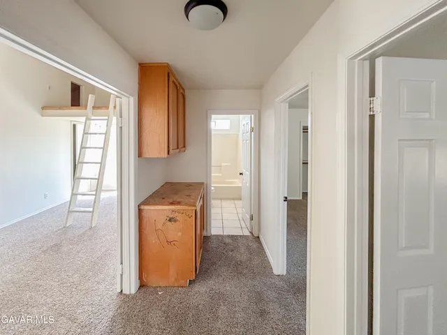 a view of a storage & utility room with a sink