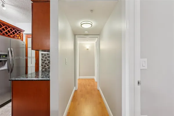 a view of a hallway with wooden floor