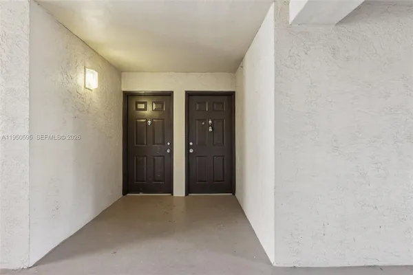 an empty room with wooden floor and mirror