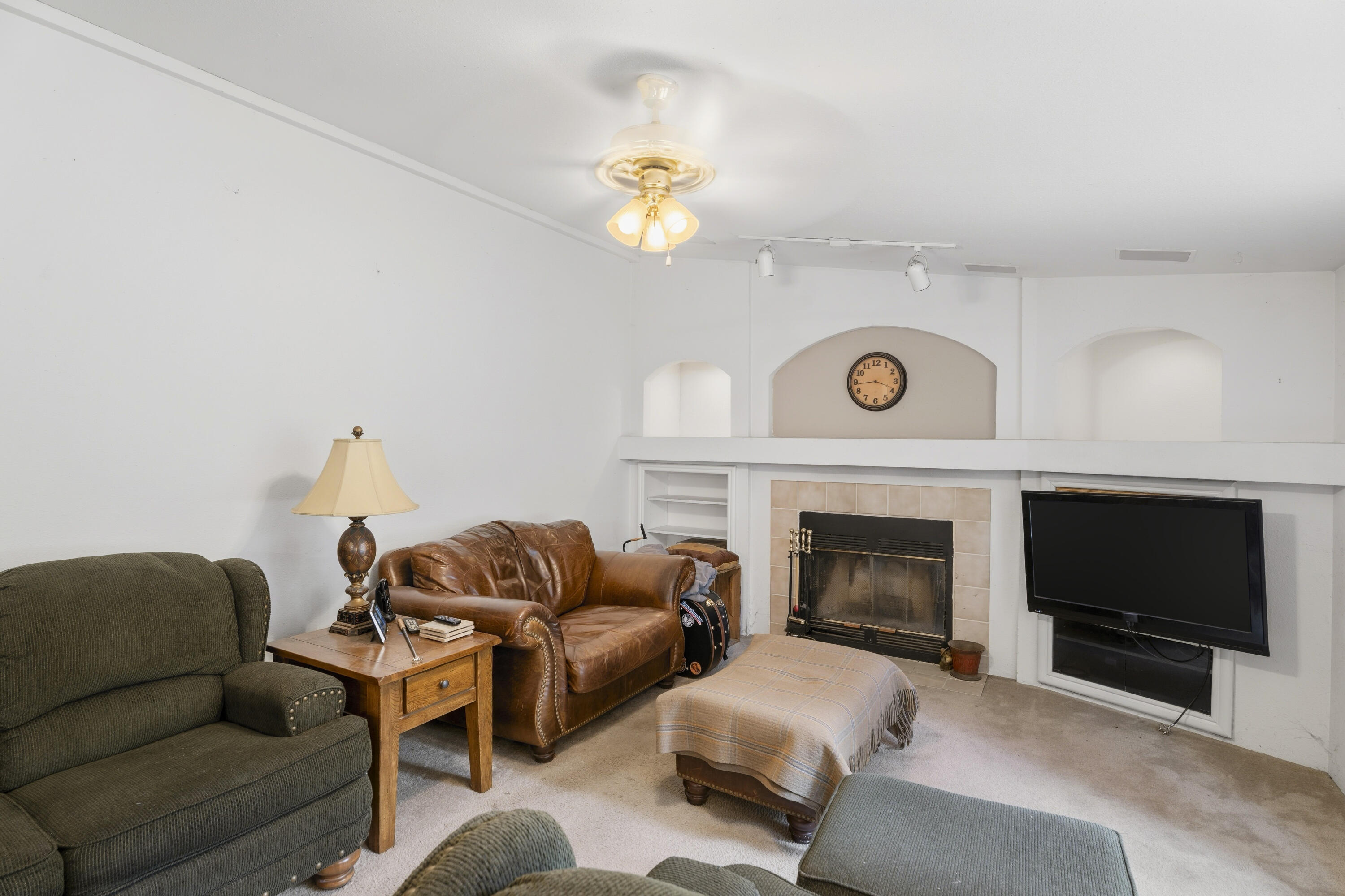 16928 Covina Road Bend, OR 97707 - Photo 8 of 48 a living room with furniture a flat screen tv and a fireplace