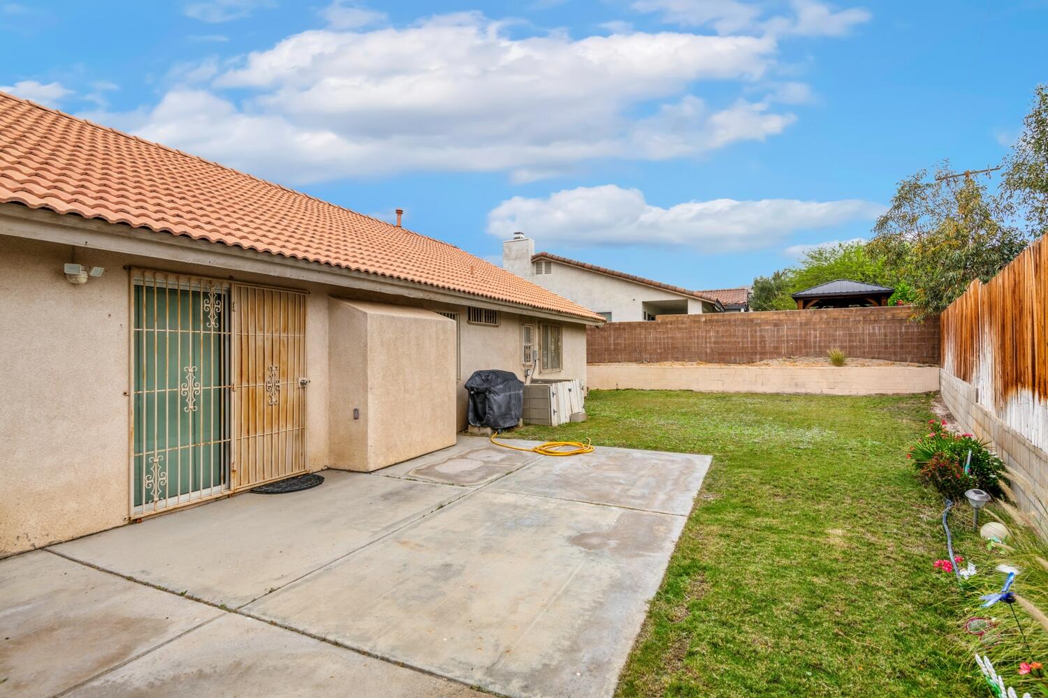 13702 Inaja Street Desert Hot Springs, CA 92240 - Photo 18 of 19 a front view of a house with garden