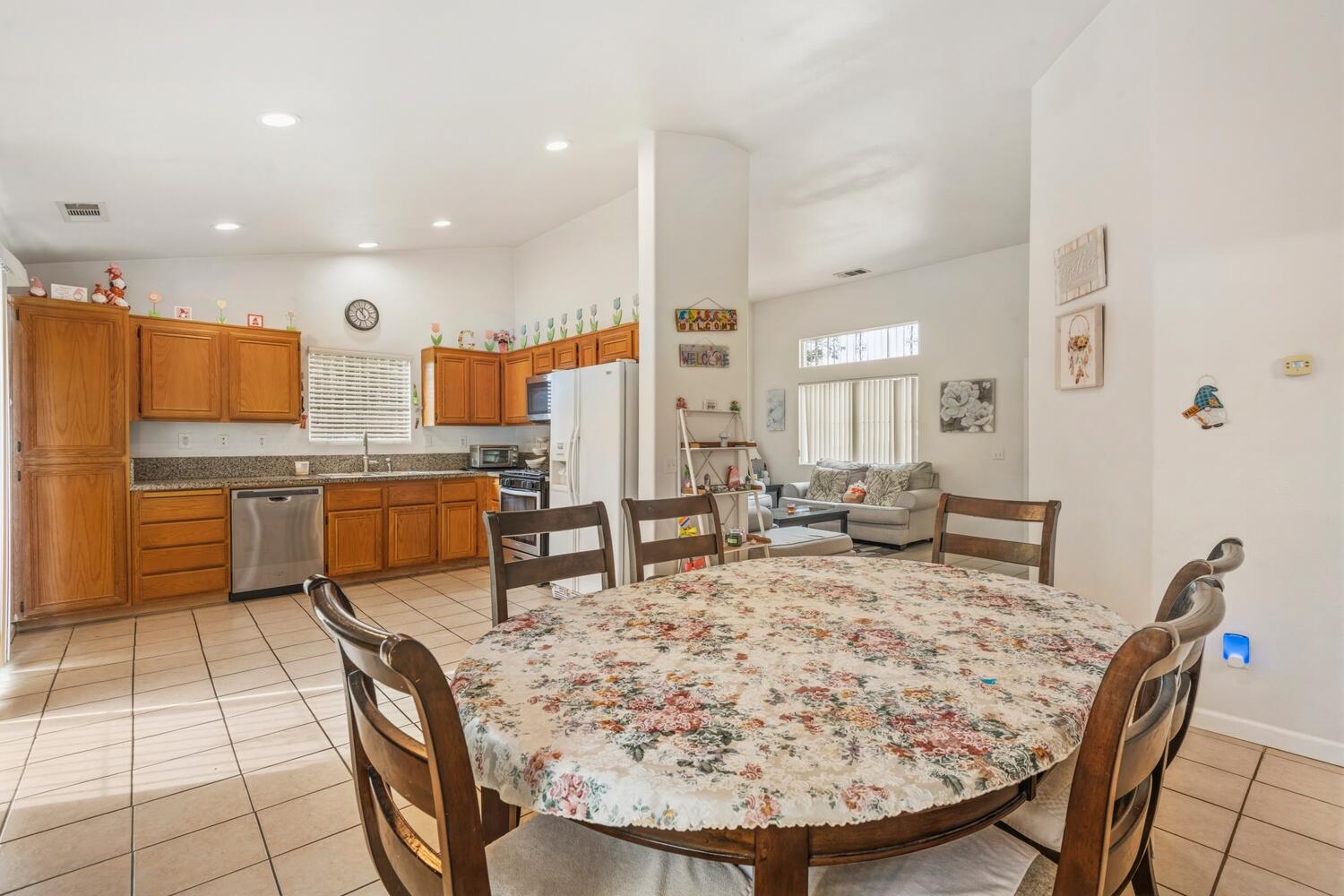 13702 Inaja Street Desert Hot Springs, CA 92240 - Photo 6 of 19 a living room with stainless steel appliances furniture a kitchen island dining table and chairs