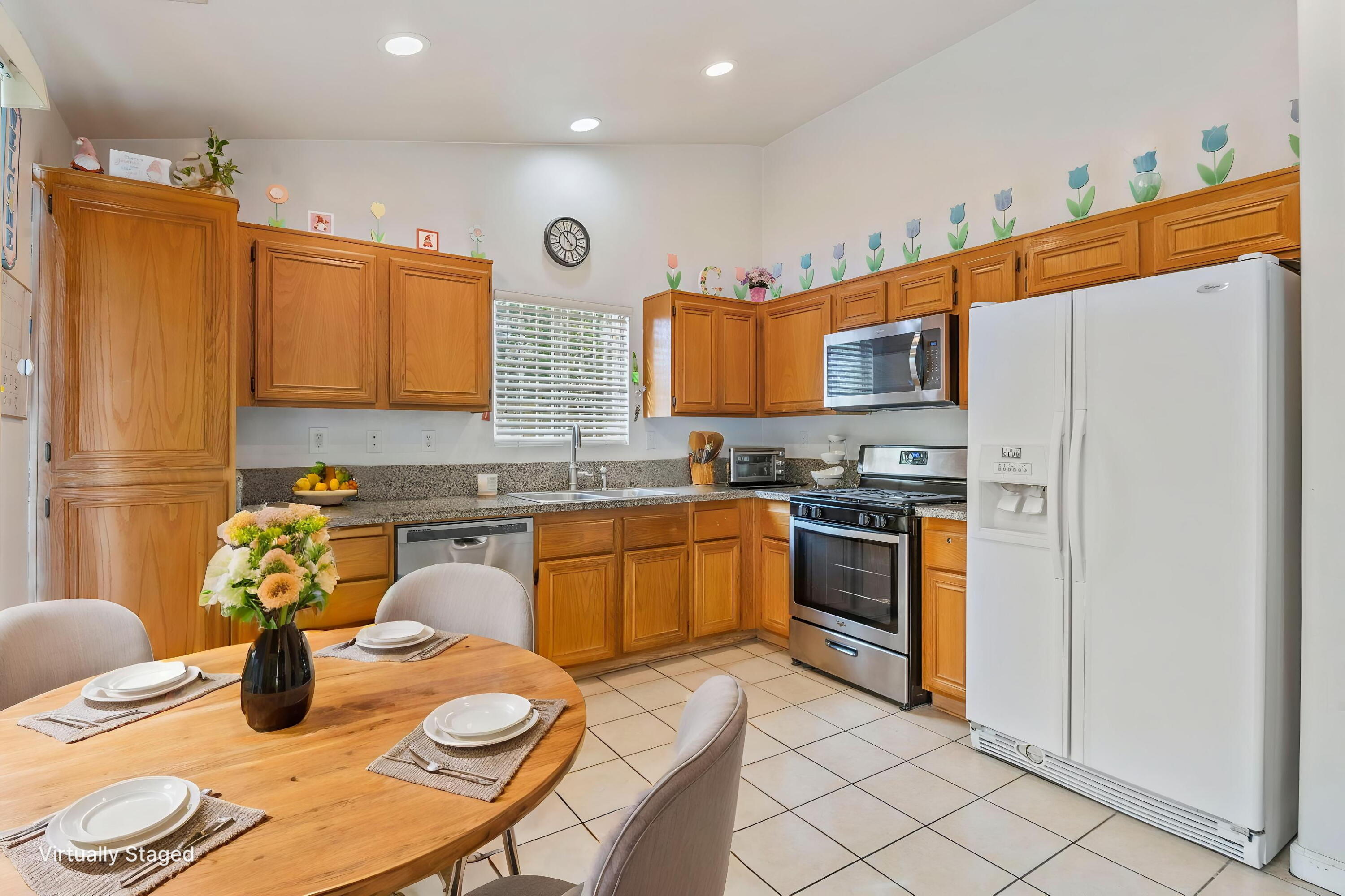 13702 Inaja Street Desert Hot Springs, CA 92240 - Photo 7 of 19 a kitchen with stainless steel appliances granite countertop a sink dishwasher stove top oven and microwave