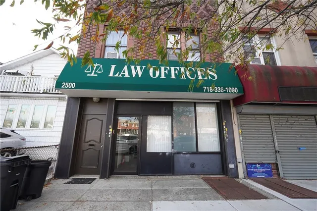 a front view of a building with retail shops