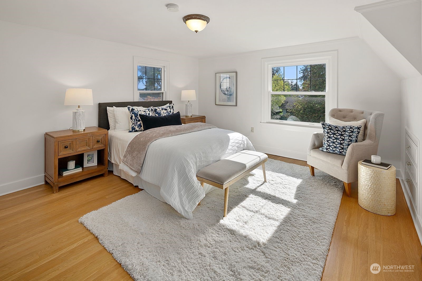1908 Northeast Naomi Place Seattle, WA 98115 - Photo 19 of 30 a spacious bedroom with a bed a couch and large window