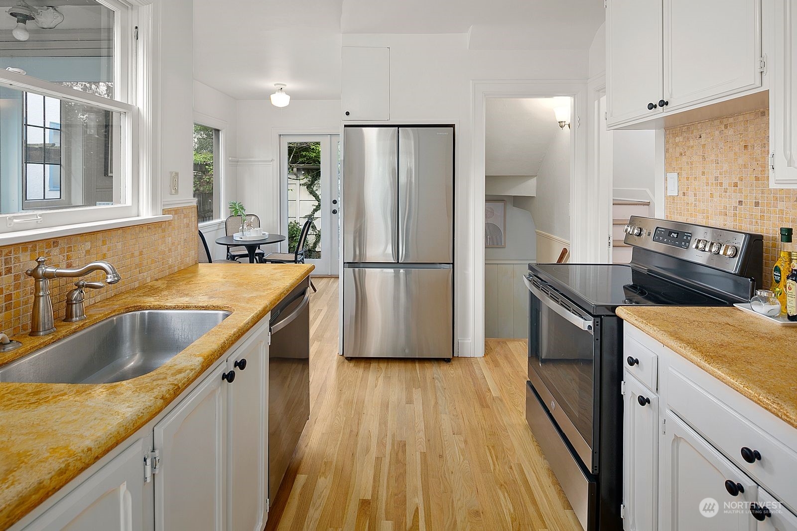 1908 Northeast Naomi Place Seattle, WA 98115 - Photo 10 of 30 a kitchen with a sink stove and refrigerator