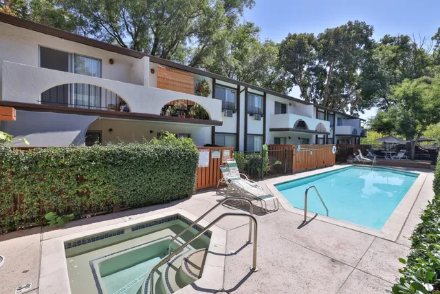 a view of a patio with table and chairs with wooden fence and plants