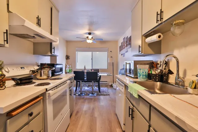 a kitchen with a sink appliances and cabinets